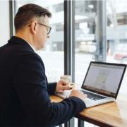 Man working on a laptop in a cafe, CampusCE Blog, What can data do for you?